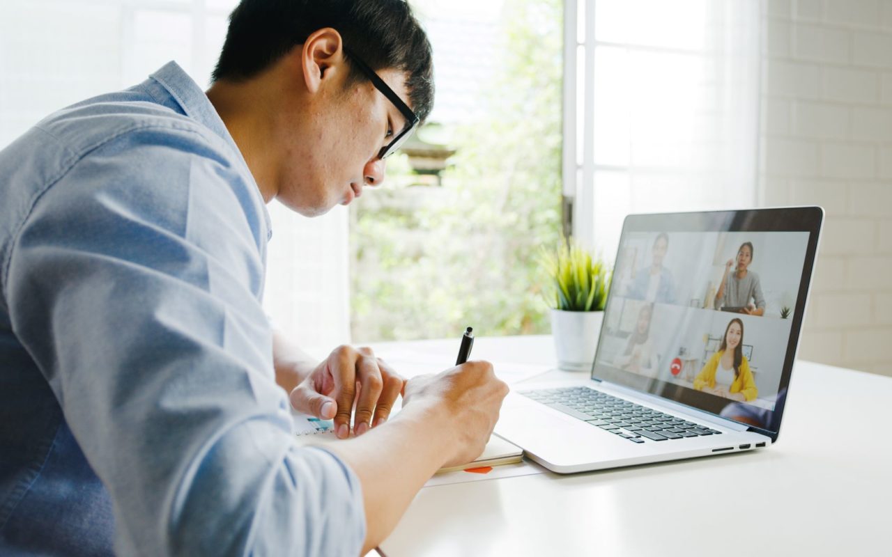 man with eye glasses working on laptop from home