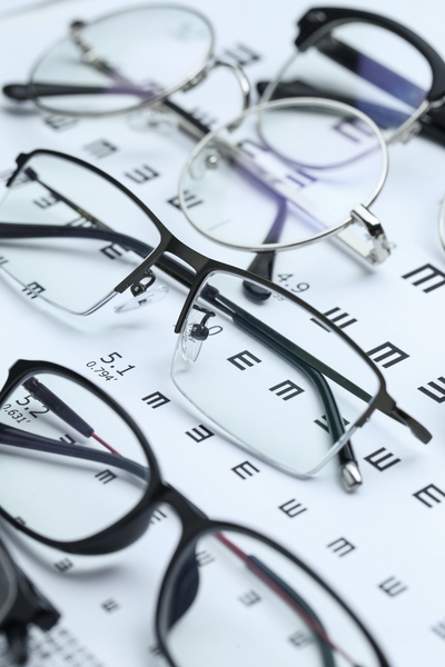 Variety of glasses on top of an eye chart